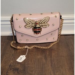 Womens pink purse comes with a second strap.